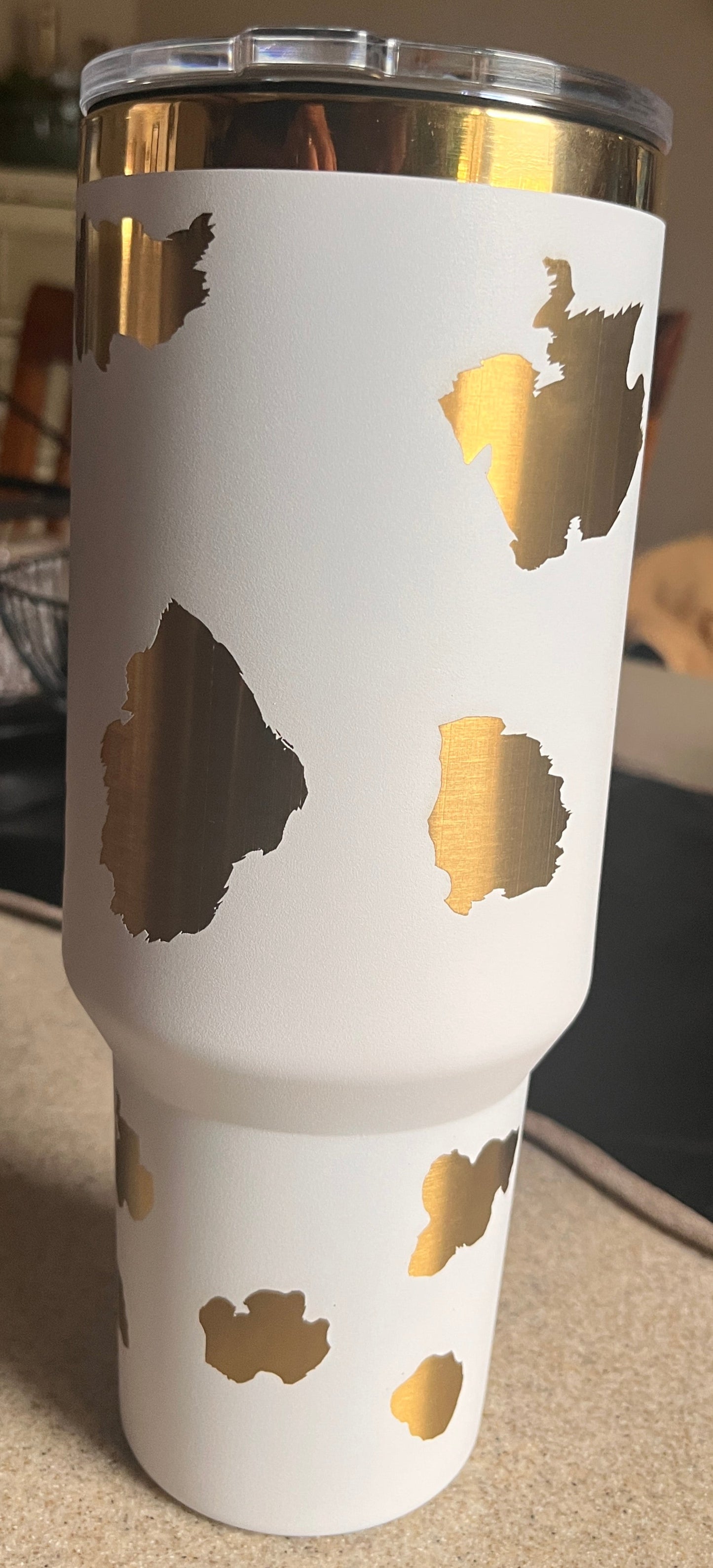 White tumbler with gold leaf design
