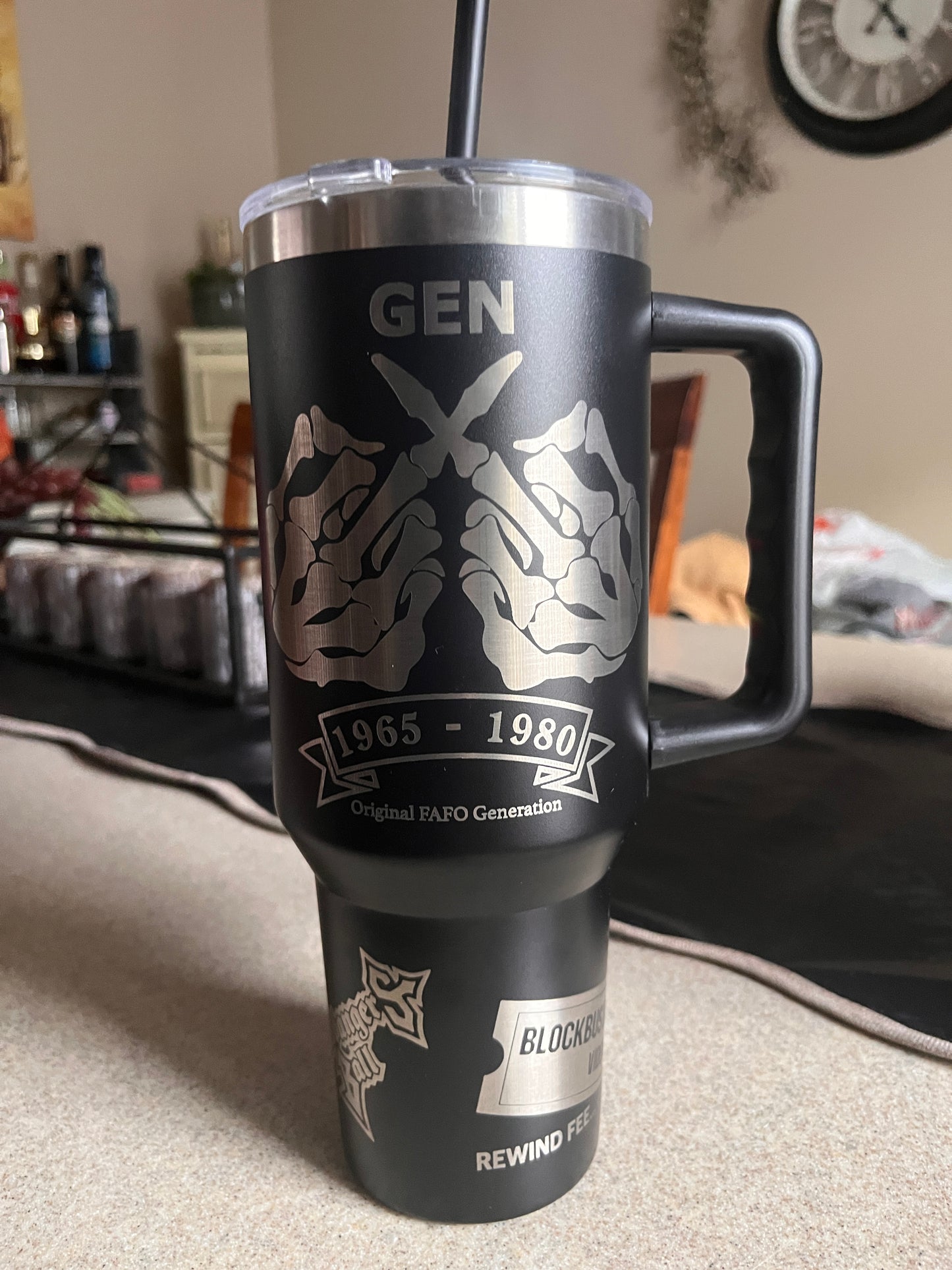 Black and silver cylindrical product with branding on a surface