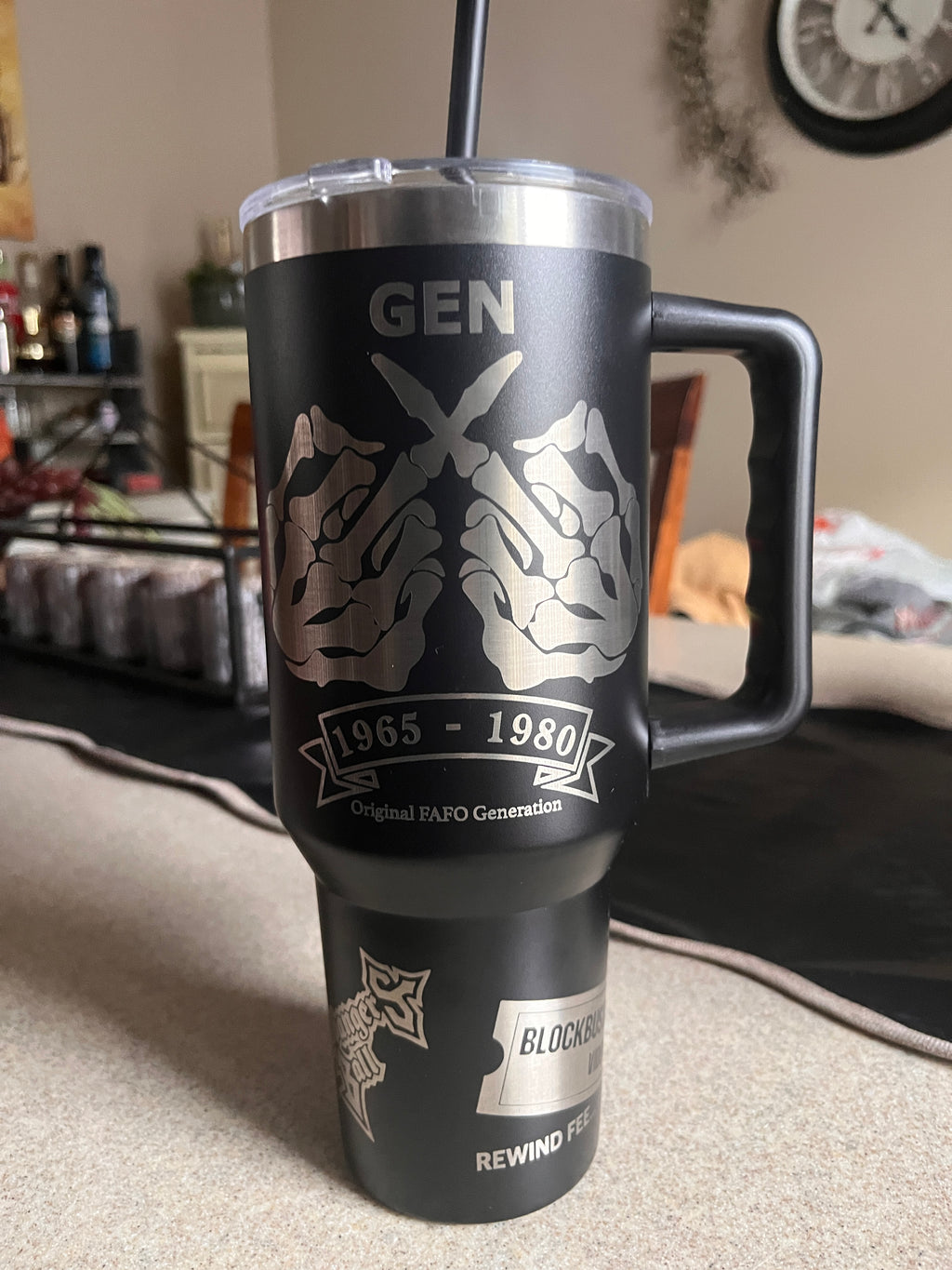 Black and silver cylindrical product with branding on a surface